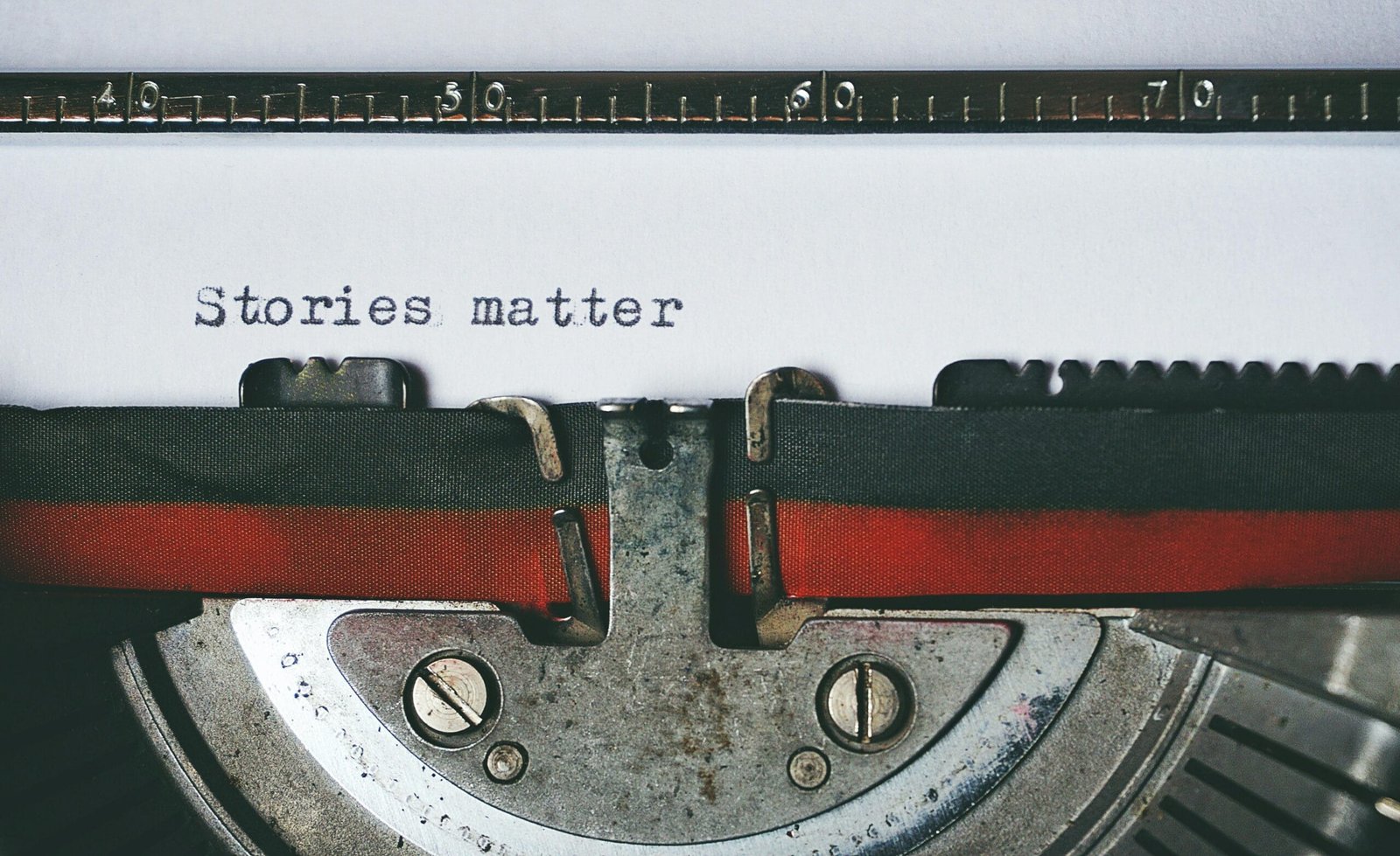 Writing words on a typewriter. The old-fashioned way.